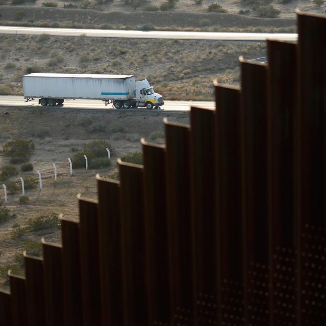 © Bloomberg. A truck drives along a road in Juarez, Mexico, near a border fence that separates the U.S. and Mexico in Sunland Park, New Mexico, U.S., on Wednesday, Nov. 8, 2017. If the renegotiation of the North American Free Trade Agreement encounters trouble, it could impact other areas of cooperation with the U.S. such as security and immigration, according to Mexican Foreign Minister Luis Videgaray. 