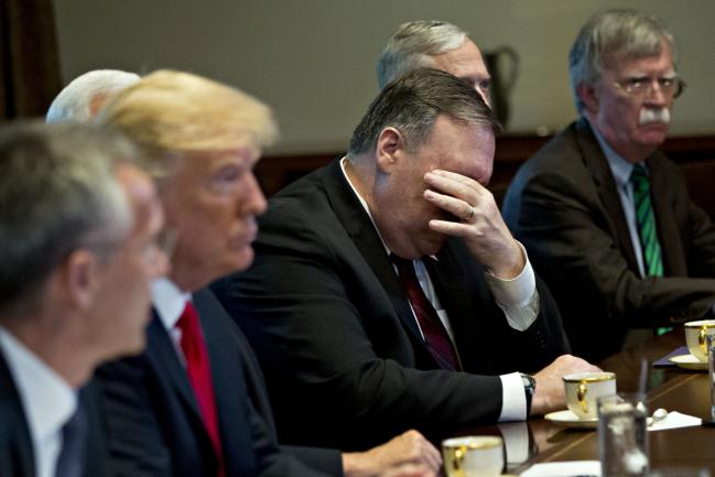 © Bloomberg. Mike Pompeo, U.S. secretary of state, center, rubs his face during a meeting with U.S. President Donald Trump, second left, and Jens Stoltenberg, secretary general of the North Atlantic Treaty Organization (NATO), left, in the Cabinet Room of the White House in Washington, D.C. U.S., on Thursday, May 17, 2018. The White House said the two leaders will be discussing the upcoming NATO Summit in July. 