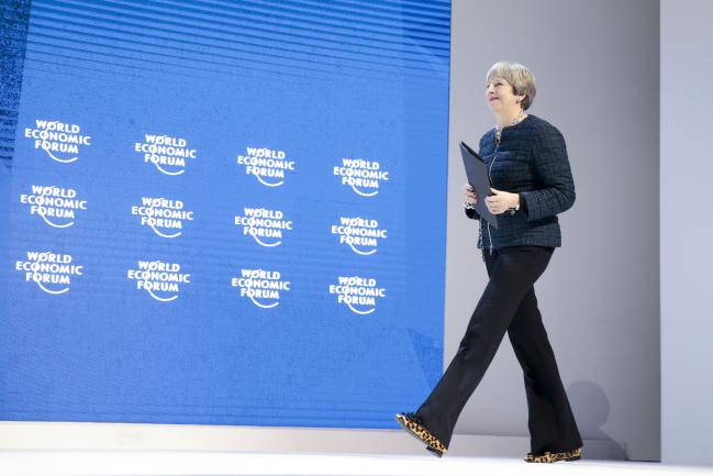 © Bloomberg. Theresa May, U.K. prime minister, arrives on stage to deliver a speech during a special session on day three of the World Economic Forum (WEF) in Davos, Switzerland, on Thursday, Jan. 25, 2018. World leaders, influential executives, bankers and policy makers attend the 48th annual meeting of the World Economic Forum in Davos from Jan. 23 - 26.