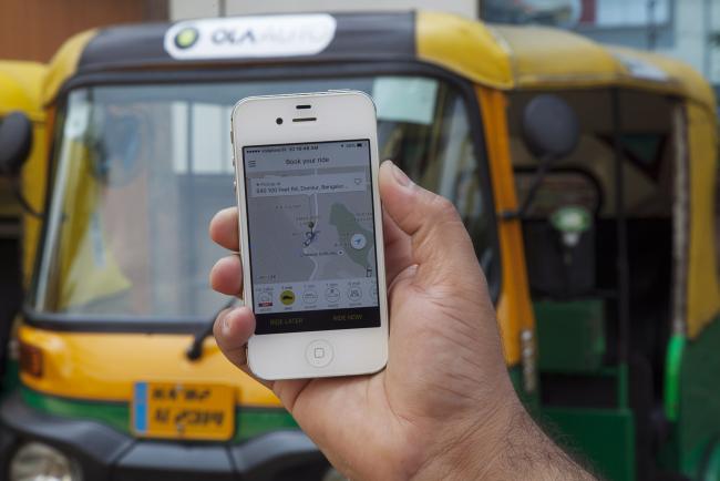 © Bloomberg. The app of ride-hailing service Ola, owned by ANI Technologies Pvt., is displayed in Bengaluru, India. 