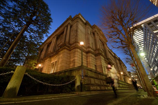 © Bloomberg. Pedestrians walk past the Bank of Japan (BOJ) headquarters in Tokyo, Japan, on Monday, March 11, 2019. An increasing number of economists see additional stimulus as the BOJ’s next policy step, while they are unanimous in forecasting no change at this week’s board meeting. Photographer: Akio Kon/Bloomberg