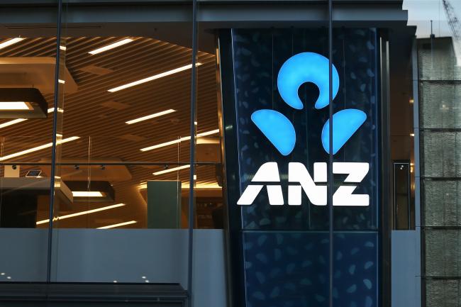 © Bloomberg. The Australia & New Zealand Banking Group Ltd. (ANZ Bank) logo is illuminated at a branch in Sydney, Australia. Photographer: Brendon Thorne/Bloomberg