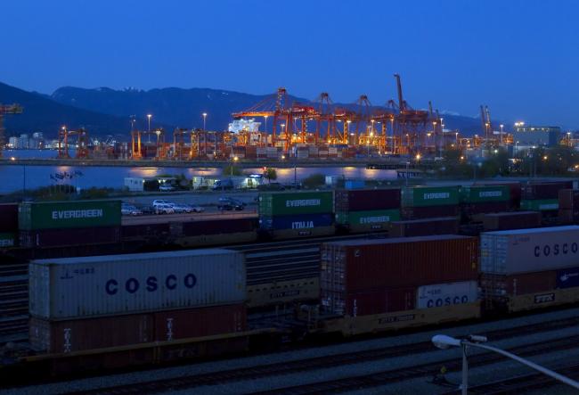 © Bloomberg. Freight containers sit loaded onto rail cars as the Port Metro Vancouver terminal stands at dusk in Vancouver, British Columbia, Canada, on Tuesday, April 16, 2013.  Photographer: Ben Nelms/Bloomberg