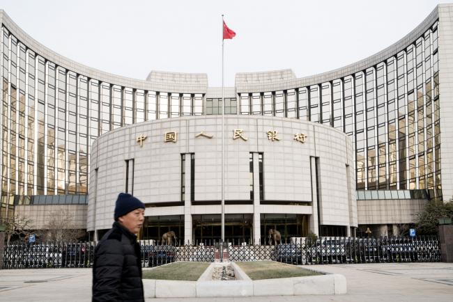 © Bloomberg. A pedestrian walks past the People's Bank of China headquarters in Beijing, China. Photographer: Giulia Marchi/Bloomberg