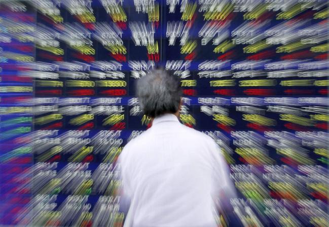 © Bloomberg. A pedestrian looks at an electronic stock board outside a securities firm in Tokyo, Japan, on Wednesday, June 16, 2010. Japanese stocks rose for a fifth day as growth in New York manufacturing, higher sales forecast for semiconductors and rising commodity prices boosted optimism a recovery in the global economy will boost corporate earnings.