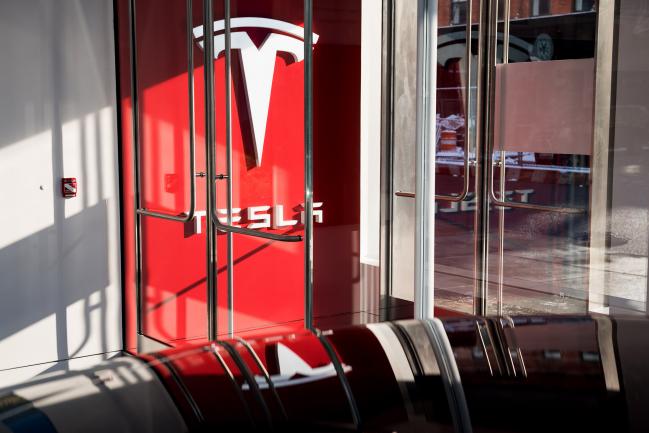 © Bloomberg. Signage is displayed at the entrance to the new Tesla Inc. showroom in New York. Photographer: Mark Kauzlarich/Bloomberg