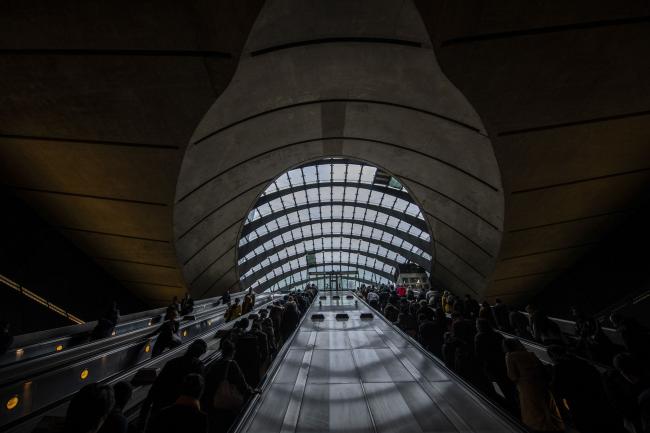 © Bloomberg. Commuters exit the Canary Wharf London Underground station at the Canary Wharf financial, shopping and business district in London, U.K., on Thursday, June 13, 2019. 