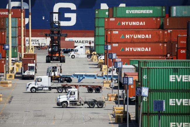 © Bloomberg. Semi-trucks wait to be loaded with shipping containers in the APM shipping terminal at the Port of Los Angeles in Los Angeles, California, U.S., on Tuesday, May 7, 2019. The terminal is planning to replace diesel trucks and human workers. It has already ordered an electric, automated carrier from Finnish manufacturer Kalmar, part of the Cargotec Corp., that can fulfill the functions of three kinds of manned diesel vehicles: a crane, top-loader and truck. Photographer: Patrick T. Fallon/Bloomberg