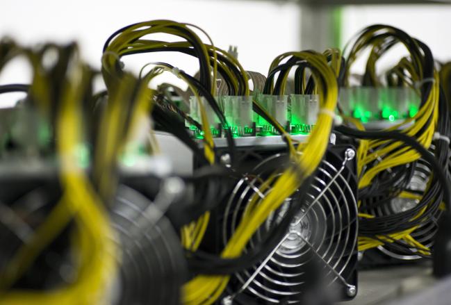 © Bloomberg. Bitmain Technologies Inc. application specific integrated circuit (ASIC) units sit on a shelf inside the DMM Mining Farm, operated by DMM.com Co., in Kanazawa, Japan, on Tuesday, March 20, 2018. Japan is moving toward legalizing initial coin offerings, even as countries such as China and the U.S. restrict the fundraising technique because of their risks for investors. A government-backed study group laid out basic guidelines for further adoption of ICOs, according to a report published on April 5. 