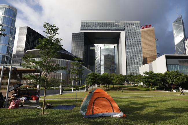 © Bloomberg. A protester's tent stands on Tamar Park in front of the Central Government Complex on June 21. Photographer: Justin Chin/Bloomberg