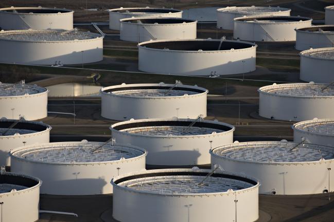 © Bloomberg. Oil storage tanks stand in this aerial photograph taken above Cushing, Oklahoma, U.S.