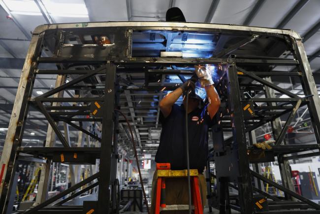 © Bloomberg. An employee welds the frame of an electric vehicle at the BYD Coach and Bus factory in Lancaster, California, U.S., on Thursday, Oct. 5, 2017. BYD unveiled the newly expanded 450,000 square foot factory on Friday, North America's largest electric bus manufacturing facility. Photographer: Patrick T. Fallon/Bloomberg