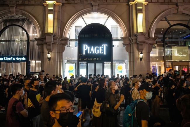 © Bloomberg. Protesters gather outside a Piaget store on Canton Road in Tsim Sha Tsui, Hong Kong on July 7. 