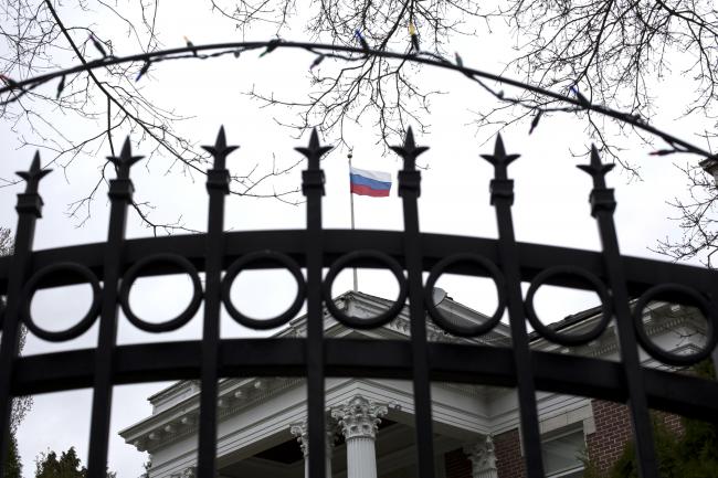© Bloomberg. A Russian flag flies above the residence of the consul-general in Seattle, Washington, U.S., on Monday, Mar. 26, 2018. President Donald Trump ordered 60 Russian diplomats the U.S. considers spies to leave the country and closed Russia's consulate in Seattle in response to the nerve-agent attack on a former Russian spy in the U.K., as European allies and Canada took similar measures.