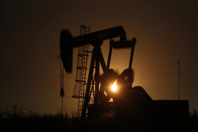 © Bloomberg. The silhouette of an electric oil pump jack is seen at dusk in the oil fields surrounding Midland, Texas, U.S., on Tuesday, Nov. 7, 2017. Nationwide gross oil refinery inputs will rise above 17 million barrels a day before the year ends, according to Energy Aspects, even amid a busy maintenance season and interruptions at plants in the U.S. Gulf of Mexico that were clobbered by Hurricane Harvey in the third quarter. Photographer: Luke Sharrett/Bloomberg