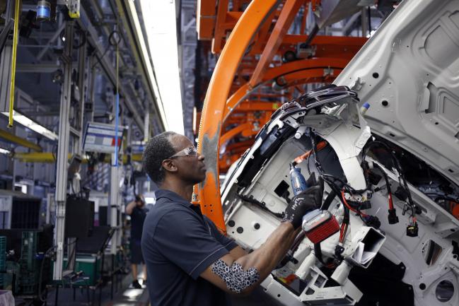 © Bloomberg. A worker assembles a Bayerische Motoren Werke AG (BMW) vehicle at the BMW Manufacturing Co. plant in Greer, South Carolina, U.S. on Thursday, May 10, 2018. Markit is scheduled to release manufacturing figures on May 23. Photographer: Bloomberg/Bloomberg