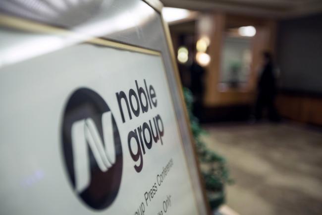 © Bloomberg. Noble Group Ltd. signage sits on display outside during an investor day in Singapore, on Monday, Aug. 17, 2015.  