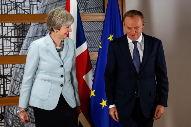 © Bloomberg. Theresa May, U.K. prime minister, left, and Donald Tusk, president of the European Union (EU), talk while posing for photographs ahead of a meeting at the European Commission building in Brussels, Belgium, on Friday, Dec. 8, 2017. The U.K. and the European Union struck a deal to unlock divorce negotiations, opening the way for talks on what businesses are keenest to nail down -- the nature of the post-Brexit future. 