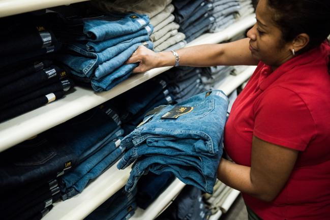 © Bloomberg. An employee restocks Levis Strauss & Co. Lee brand jeans at a J.C. Penney Co. store in the Queens borough of New York, U.S., on Monday, Nov. 20, 2017. Traditional retailers may be able to breathe a (brief) sigh of relief this weekend. Only 47 percent of U.S. consumers plan to shop online during this year's Black Friday, the post-Thanksgiving sales bonanza that kicks off the holiday season, according to a survey from Deloitte LP.