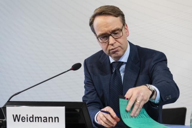 © Bloomberg. Jens Weidmann, president of the Deutsche Bundesbank, looks at documents during the German central bank’s annual news conference in Frankfurt, Germany, on Wednesday, Feb. 27, 2019. German Chancellor Angela Merkel’s cabinet agreed to extend Weidmann’s term as head of the Bundesbank by another eight years. 