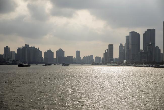 © Bloomberg. Skyscrapers of the Pudong Lujiazui Financial District stand across the Huangpu River in Shanghai, China, on Friday, Dec. 28, 2018. China announced plans to rein in the expansion of lending by the nation's regional banks to areas beyond their home bases, the latest step policy makers have taken to defend against financial risk in the world's second-biggest economy. Photographer: Qilai Shen/Bloomberg