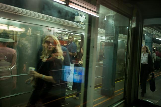 © Bloomberg. Commuters exit a train at a Wall Street subway station near the New York Stock Exchange (NYSE) in New York, U.S., on Friday, Oct. 5, 2018. A severe sell-off in technology stocks has pushed the front-month VIX futures contract to a premium relative to the second-month contract. Photographer: Michael Nagle/Bloomberg