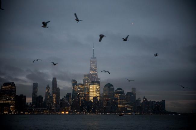 © Bloomberg. One World Trade Center (WTC) stands in the lower Manhattan skyline as birds fly over the Hudson River in Hoboken, New Jersey, U.S., on Friday, Feb. 8, 2019. U.S. stocks pared losses as technology shares buoyed indexes amid better-than-expected earnings, while Treasuries climbed as economic growth and trade concerns pushed investors out of riskier assets. Photographer: Michael Nagle/Bloomberg