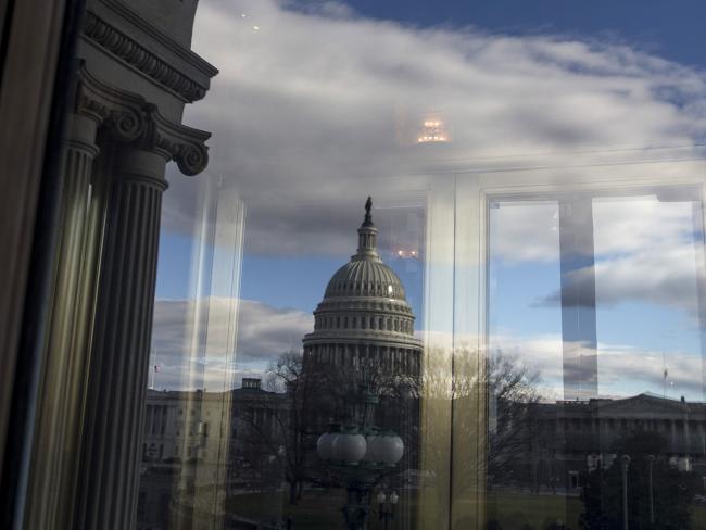 © Bloomberg. The U.S. Capitol Building is seen reflected on a window in Washington, D.C. 