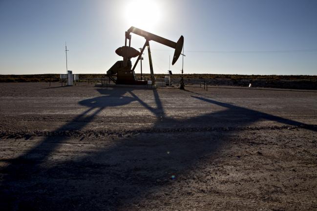 © Bloomberg. A pumpjack operates on an oil well in the Permian Basin near Orla, Texas, U.S., on Friday, March 2, 2018. Chevron, the world's third-largest publicly traded oil producer, is spending $3.3 billion this year in the Permian and an additional $1 billion in other shale basins. Its expansion will further bolster U.S. oil output, which already exceeds 10 million barrels a day, surpassing the record set in 1970. Photographer: Daniel Acker/Bloomberg