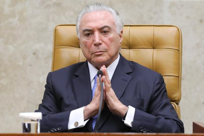 © Bloomberg. Michel Temer, Brazil's president, listens during the Federal Supreme Court's first session following the judicial recess in Brasilia, Brazil.