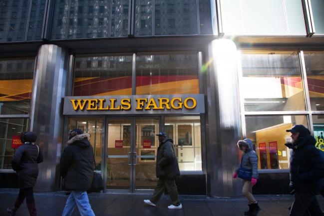 © Bloomberg. Pedestrians pass in front of a Wells Fargo & Co. bank branch in New York, U.S.