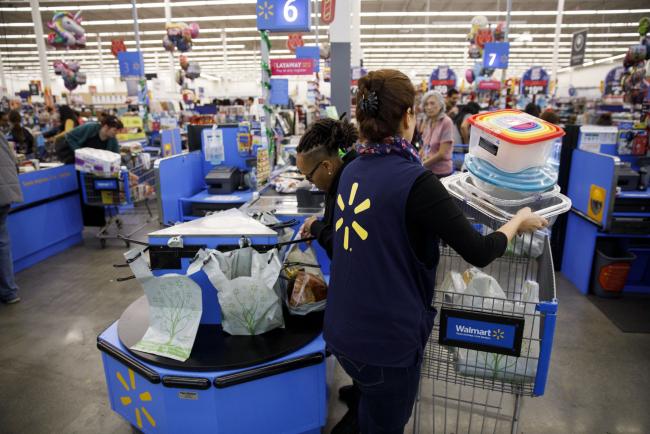© Bloomberg. An cashier places items into a customer's shopping cart at a Walmart Inc. store in Burbank, California, U.S., on Monday, Nov. 19, 2018. To get the jump on Black Friday selling, retailers are launching Black Friday-like promotions in the weeks prior to the event since competition and price transparency are forcing retailers to grab as much share of the consumers' wallet as they can. 