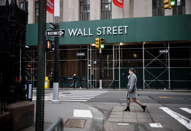 © Bloomberg. A pedestrian walks up Broadway near the New York Stock Exchange. 