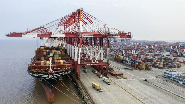 © Bloomberg. The Mediterranean Shipping Co. (MSC) Anzu container ship is docked next to gantry cranes as shipping containers sit stacked at the Yangshan Deepwater Port, operated by Shanghai International Port Group Co. (SIPG), in this aerial photograph taken in Shanghai, China, on Friday, May 10, 2019. The U.S. hiked tariffs on more than $200 billion in goods from China on Friday in the most dramatic step yet of President Donald Trump's push to extract trade concessions, deepening a conflict that has roiled financial markets and cast a shadow over the global economy. 