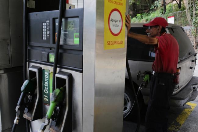 © Bloomberg. An employee fuels a vehicle at a Petroleos de Venezuela SA (PDVSA) gas station in Caracas, Venezuela, on Tuesday, May 22, 2018. The U.S. sanctions in response to Venezuela President Nicolas Maduro's contested re-election barely touch either the oil sector or country's crown jewel, oil company PDVSA. 