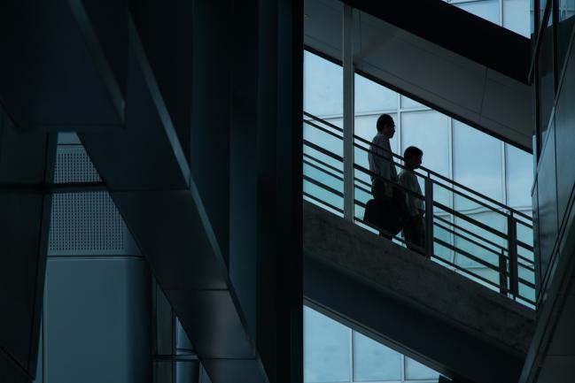 © Bloomberg. Commuters walk down a flight of stairs at the Fusionopolis research and development complex in Singapore, on Monday, May 16, 2016.  Photographer: Nicky Loh/Bloomberg