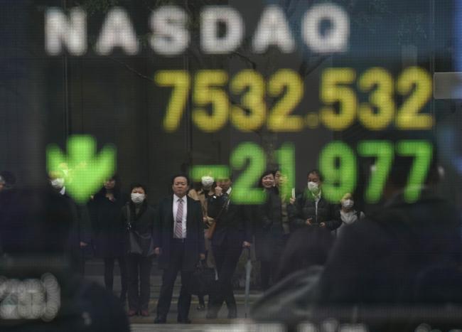 © Bloomberg. Pedestrians are reflected in an electronic stock board displaying the Nasdaq Composite Index outside a securities firm in Tokyo, Japan, on Friday, March 1, 2019. Japanese shares advanced as the latest batch of U.S. data suggested the world’s largest economy is still on a solid growth track and as the yen continued to weaken against the dollar. Photographer: Toru Hanai/Bloomberg