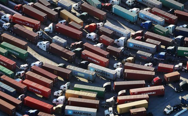 © Bloomberg. SAN PEDRO, CA - SEPTEMBER 18: Trucks stand prepared to haul shipping containers at the Port of Los Angeles, the nation's busiest container port, on September 18, 2018 in San Pedro, California. China will impose an additional $60 billion in tariffs on U.S. imports in retaliation to $200 billion in tariffs on Chinese imports set by U.S. President Donald Trump. (Photo by Mario Tama/Getty Images)