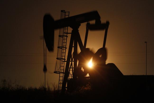 © Bloomberg. The silhouette of an electric oil pump jack is seen at dusk in the oil fields surrounding Midland, Texas, U.S., on Tuesday, Nov. 7, 2017. Nationwide gross oil refinery inputs will rise above 17 million barrels a day before the year ends, according to Energy Aspects, even amid a busy maintenance season and interruptions at plants in the U.S. Gulf of Mexico that were clobbered by Hurricane Harvey in the third quarter.