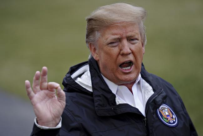 © Bloomberg. U.S. President Donald Trump speaks to members of the media on the South Lawn of the White House before boarding Marine One in Washington, D.C., U.S., on Friday, March 8, 2019. Trump called federal district Judge T.S. Ellis 