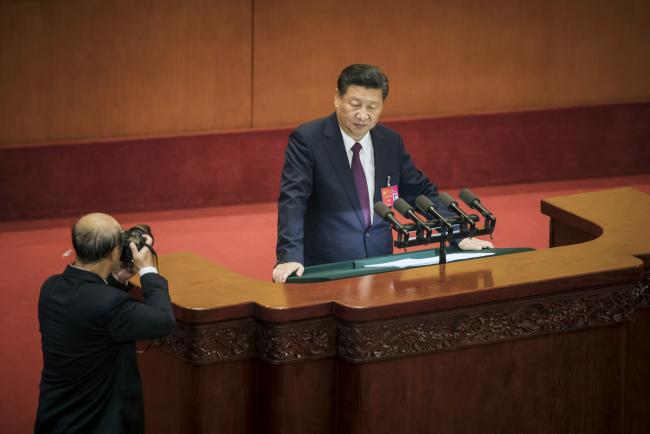 © Bloomberg. A photographer takes a photograph of Xi Jinping, China's president, as he pauses while giving a speech during the opening of the 19th National Congress of the Communist Party of China at the Great Hall of the People in Beijing, China, on Wednesday, Oct. 18, 2017. 