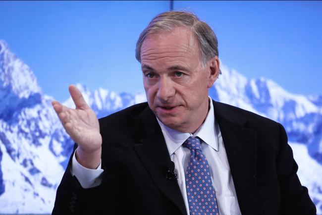 © Bloomberg. Raymond 'Ray' Dalio, billionaire and founder of Bridgewater Associates LP, gestures as he speaks during a panel session at the World Economic Forum (WEF) in Davos, Switzerland, on Wednesday, Jan. 18, 2017. World leaders, influential executives, bankers and policy makers attend the 47th annual meeting of the World Economic Forum in Davos from Jan. 17 - 20.