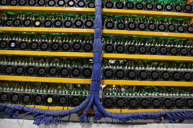 © Bloomberg. Mining machines stand at the Bitfarms cryptocurrency farming facility in Farnham, Quebec, Canada, on Wednesday, Jan. 24, 2018. Bitfarms says it's making more than $250,000 a day from minting Bitcoin, other virtual currencies and fees at four sites in the province. 