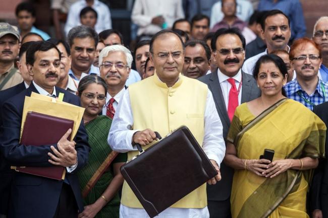 © Bloomberg. Arun Jaitley, center, with Nirmala Sitharaman in 2014. Photographer: Graham Crouch/Bloomberg