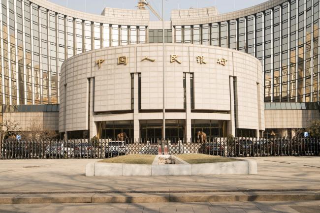 © Bloomberg. The People's Bank of China headquarters stand in Beijing, China, on Monday, Feb. 26, 2018. China's Communist Party is set to repeal presidential term limits in a move that would allow Xi Jinping to rule beyond 2023, completing the country's departure from a political system based on collective leadership. 