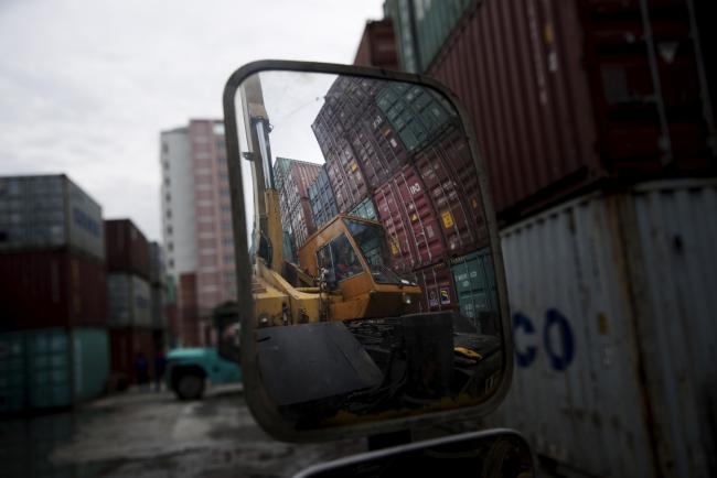 &copy Bloomberg. A truck-mounted crane operator is reflected in a mirror at the S.V. Depot Co. depot in Bangkok, Thailand on Friday, July 21, 2017. Near-record foreign exchange reserves and a current-account surplus have burnished the baht's appeal as a regional haven and attracted foreign capital to Thai bonds. The baht is a complication for policy makers trying to nurture a recovery in an economy where exports account for about 70 percent of gross domestic product. 