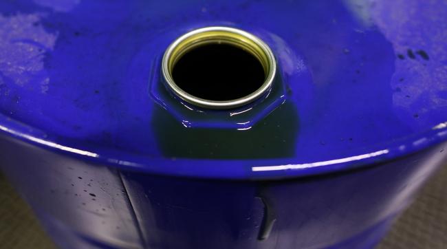 © Bloomberg. Excess fluid sits on the rim of a barrel of oil based lubricant at Rock Oil Ltd.'s factory in Warrington, U.K., on Monday, March 13, 2017. Oil declined after Saudi Arabia told OPEC it raised production back above 10 million barrels a day in February, reversing about a third of the cuts it made the previous month. Photographer: Chris Ratcliffe/Bloomberg