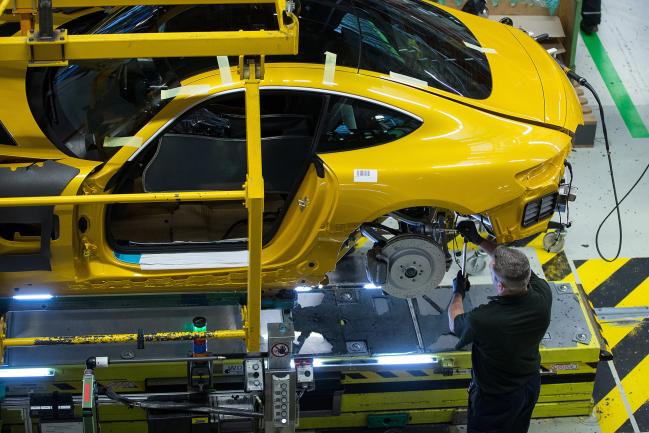 © Bloomberg. An employee fits a brake disc assembly to a yellow Mercedes-Benz AG AMG GT high performance luxury automobile during assembly at the automaker's plant in Sindelfingen, Germany, on Monday, Dec. 18, 2017. The 2018 Mercedes-Benz GT R sports car sits at the top of the Mercedes AMG GT line, with a 4.0-liter V8 bi-turbo engine that gets 577 horsepower and can hit 60 mph in 3.5 seconds. Photographer: Krisztian Bocsi/Bloomberg