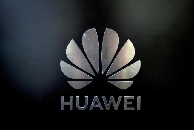 © Bloomberg. The logo for Huawei Technologies Co. is seen at the company's event to unveil the 