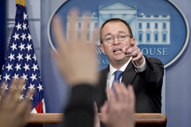 © Bloomberg. Mick Mulvaney, director of the Office of Management and Budget (OMB), takes a question during a press briefing at the White House in Washington, D.C., U.S., on Friday, Jan. 19, 2018. Federal government funding runs out at midnight Friday. Legislation to extend the deadline passed the House on Thursday and is set for a showdown in the Senate Friday, in which Democrats are poised to block the bill.